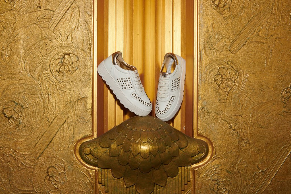 A close up of white Ravel trainers with metallic detailing